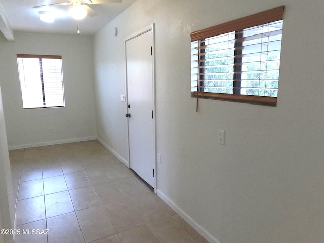 interior space with ceiling fan