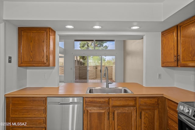 kitchen featuring kitchen peninsula, range, and sink