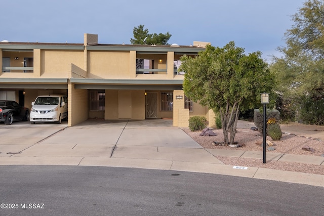 townhome / multi-family property featuring a carport