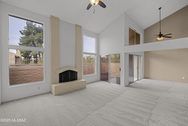 living room with a fireplace, light carpet, high vaulted ceiling, and ceiling fan