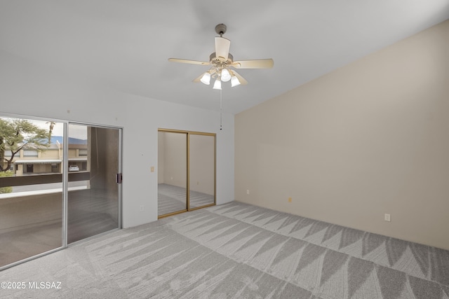 unfurnished bedroom with carpet flooring, ceiling fan, and multiple closets