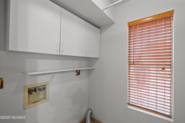 laundry area featuring hookup for a washing machine and cabinets