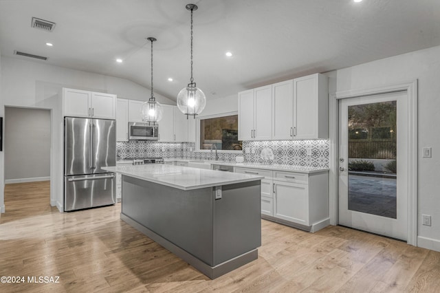 kitchen with pendant lighting, white cabinetry, a center island, and stainless steel appliances