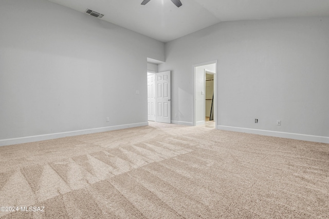 unfurnished bedroom with ceiling fan, light colored carpet, and lofted ceiling