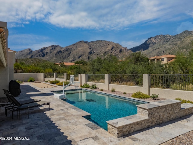 view of swimming pool featuring a mountain view and a patio