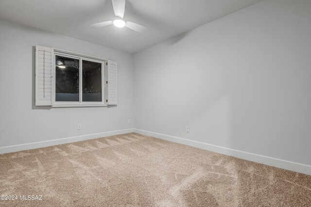 unfurnished room featuring ceiling fan and carpet floors