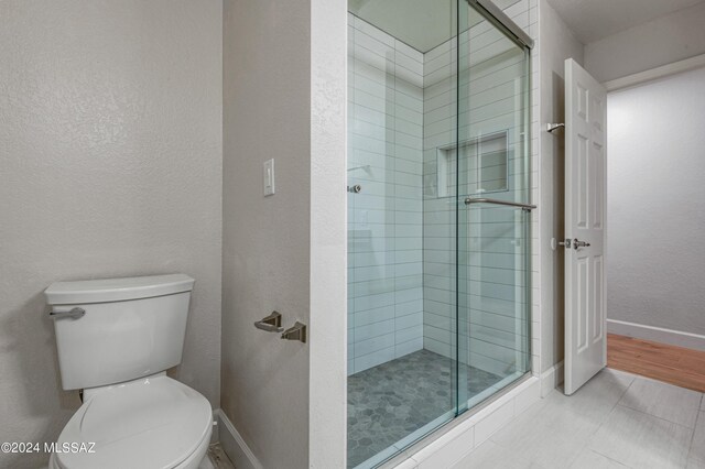 bathroom featuring toilet and walk in shower