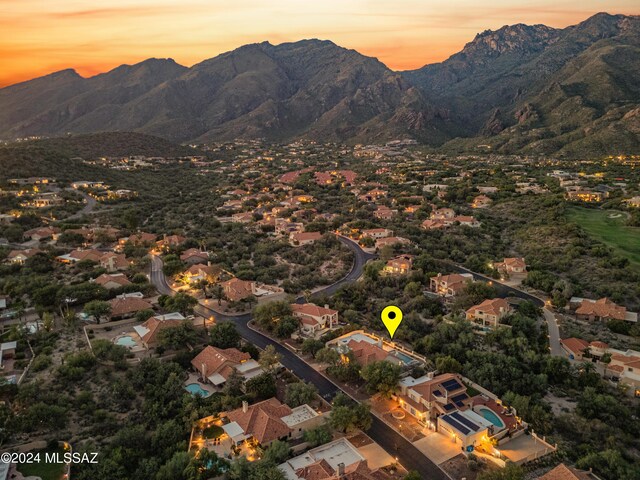 aerial view at dusk featuring a mountain view