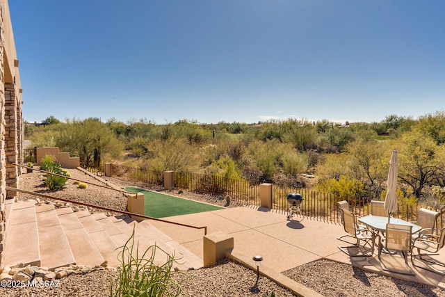 view of swimming pool with a patio and fence