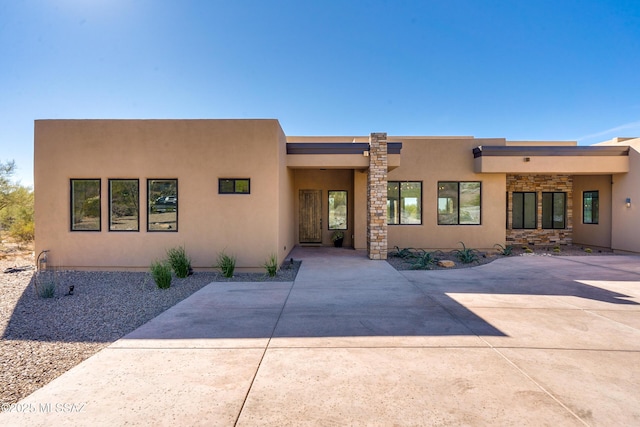 pueblo revival-style home featuring stucco siding