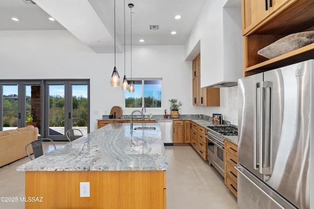 kitchen with high end appliances, concrete floors, a sink, light stone counters, and recessed lighting