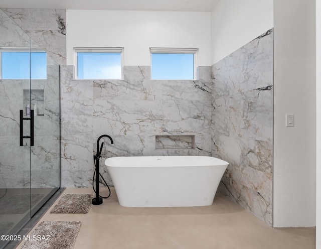 full bathroom with a soaking tub and a marble finish shower