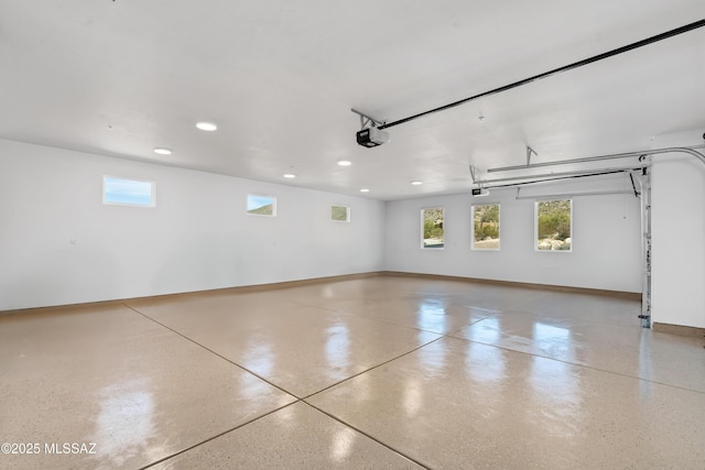garage featuring recessed lighting, baseboards, and a garage door opener
