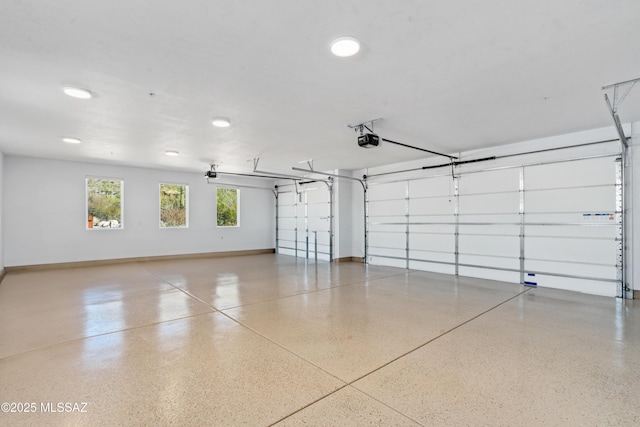 garage with a garage door opener and baseboards