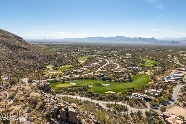 drone / aerial view of a mountain backdrop and a golf club