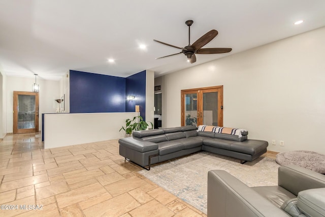 living room with ceiling fan and vaulted ceiling