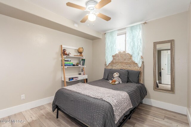 bedroom with ceiling fan and light hardwood / wood-style flooring