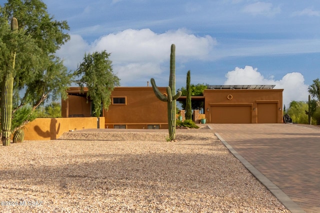 pueblo revival-style home with a garage