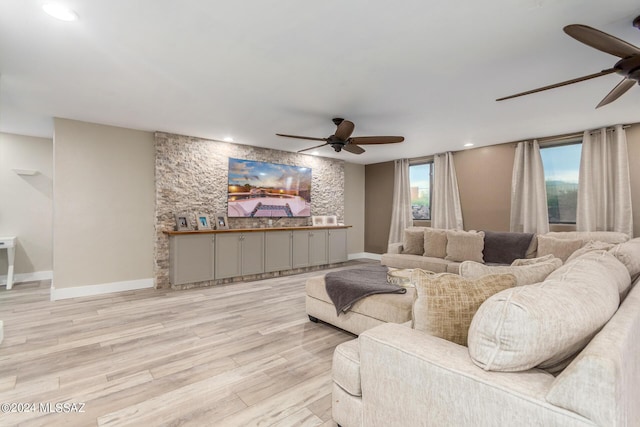 living room featuring ceiling fan and light hardwood / wood-style flooring