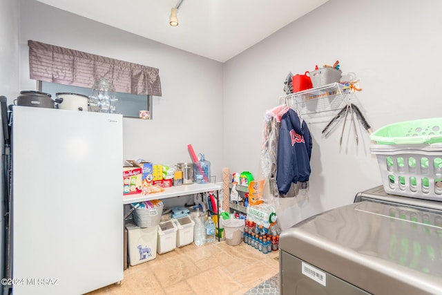 laundry area with washing machine and dryer and track lighting