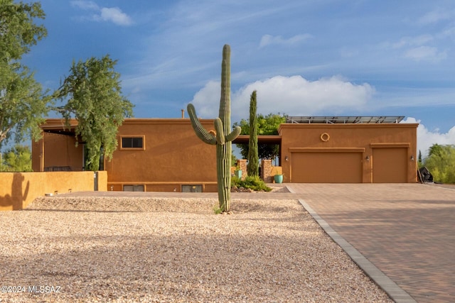 pueblo revival-style home with a garage