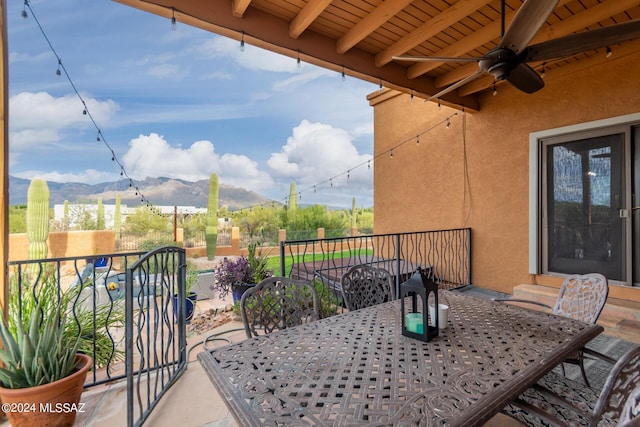 view of patio / terrace featuring a balcony, a mountain view, and ceiling fan