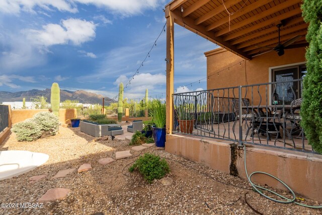 view of patio with a mountain view and ceiling fan