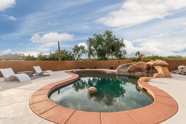 view of swimming pool with a patio area