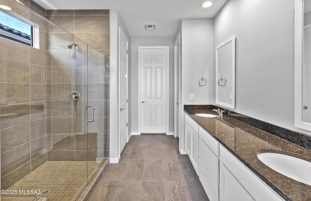 bathroom featuring walk in shower and vanity