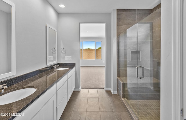 bathroom with tile patterned flooring, vanity, and a shower with shower door