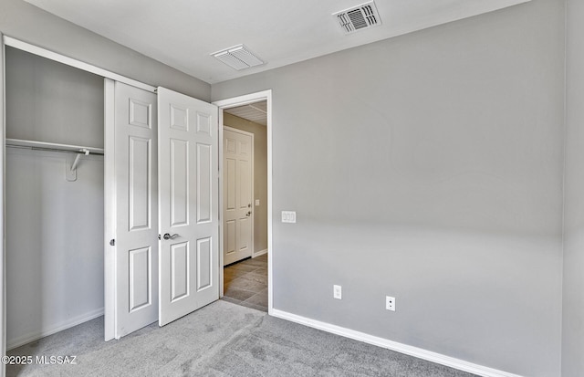 unfurnished bedroom featuring carpet floors and a closet