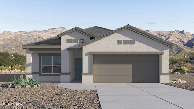 view of front of home featuring a mountain view and a garage