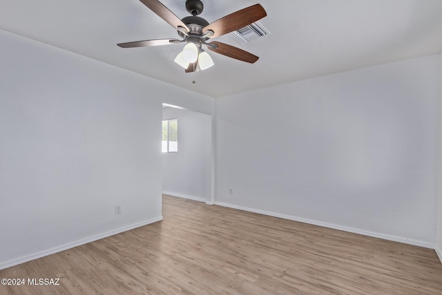 spare room with ceiling fan and light wood-type flooring