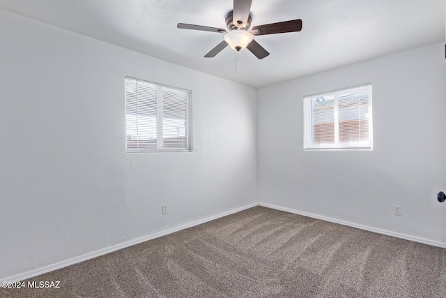 empty room featuring carpet floors and ceiling fan