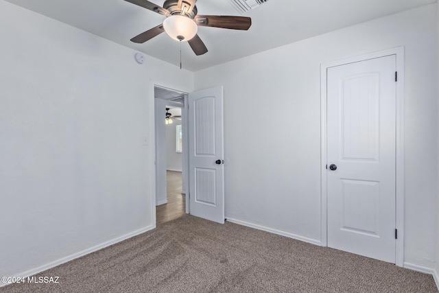 unfurnished bedroom with ceiling fan and carpet