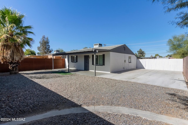 rear view of property with a patio area and cooling unit