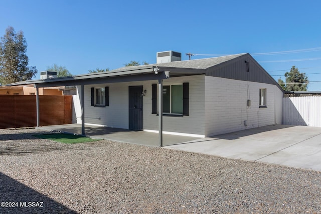 rear view of house featuring a patio area and cooling unit