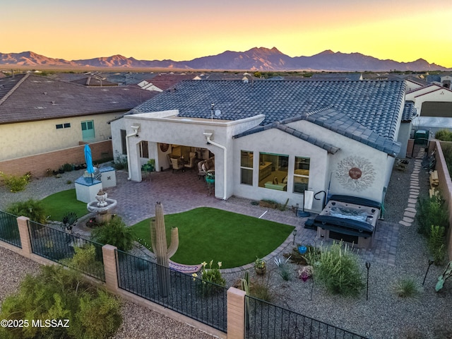 2333 E Copper Valley Way, Green Valley, AZ 85614 - back of house at dusk featuring a patio, a mountain view, and a fenced backyard