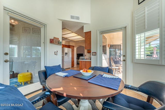 dining space with a towering ceiling