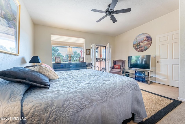 carpeted bedroom featuring access to exterior and ceiling fan