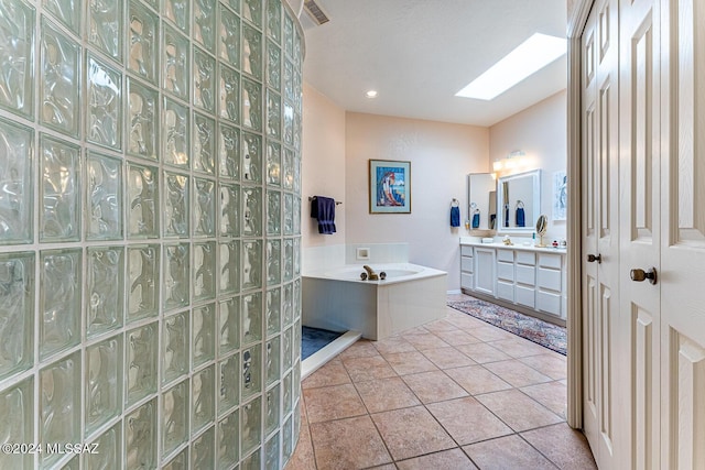 bathroom with vanity, tile patterned floors, and a skylight