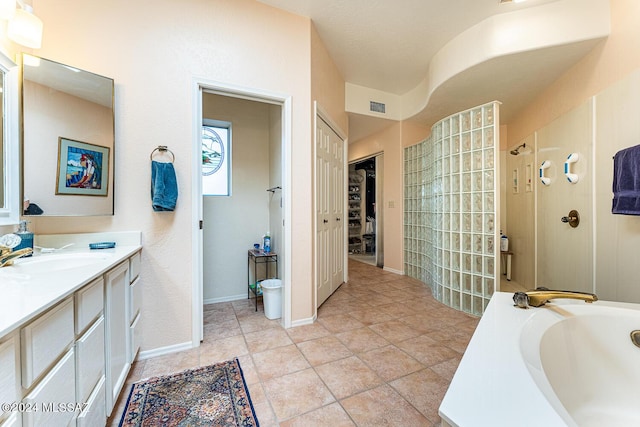 bathroom featuring vanity, tile patterned floors, and plus walk in shower