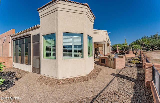 view of side of property featuring area for grilling