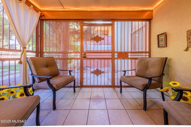 living area featuring plenty of natural light and light tile patterned flooring