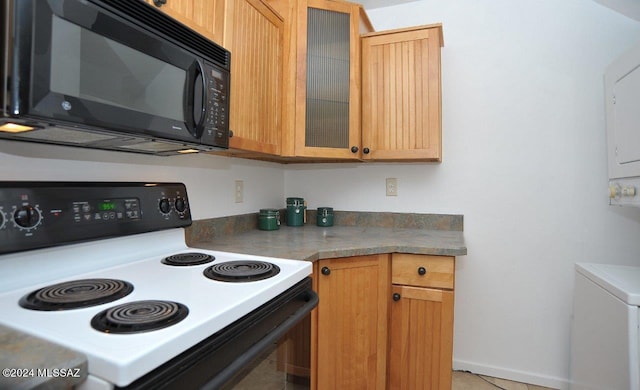 kitchen featuring electric stove and light tile patterned floors