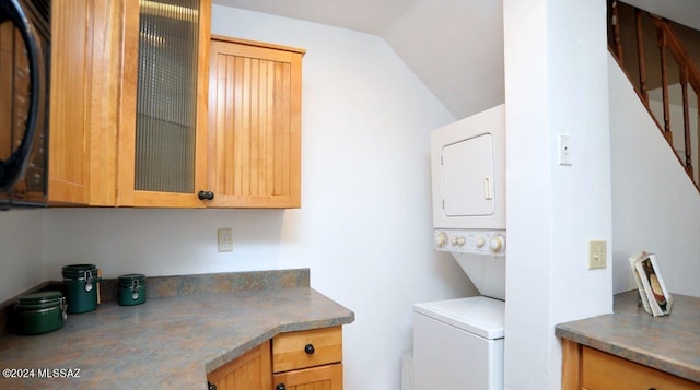 laundry area featuring stacked washer and dryer