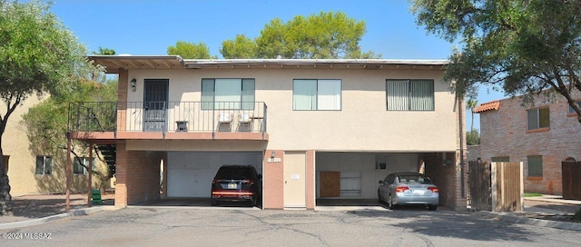 view of front of home featuring a balcony and a garage