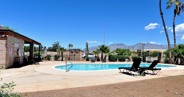 view of swimming pool featuring a mountain view and a patio area