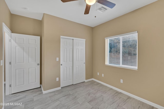 unfurnished bedroom with ceiling fan and a closet