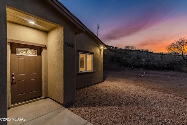 view of exterior entry at dusk